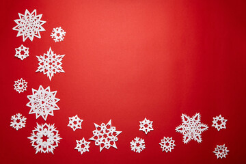 Christmas decoration with white paper snowflakes on red