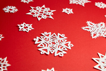 Christmas decoration with white paper snowflakes on red