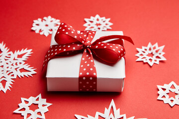 Christmas gift box with white snowflakes on red
