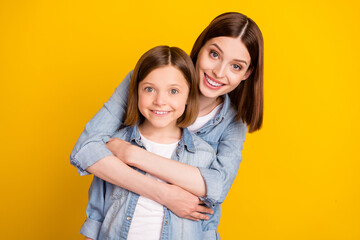 Photo of sweet shiny siblings dressed denim shirts hugging smiling isolated yellow color background