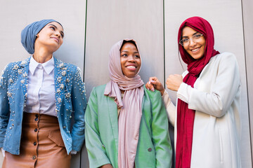 Beautiful muslim girl wearing hijab bonding outdoors