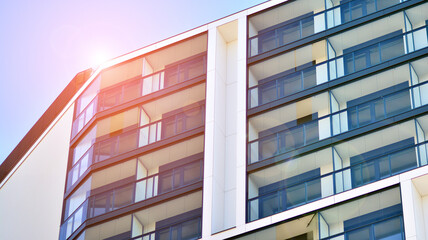 Modern apartment building. Modern urban architecture and details of building facade. Sunlight.