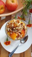 Dessert with ricotta, peach, apple and walnuts on a white plate