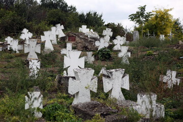 Old crosses and monuments in the cemetery.
Unknown graves
