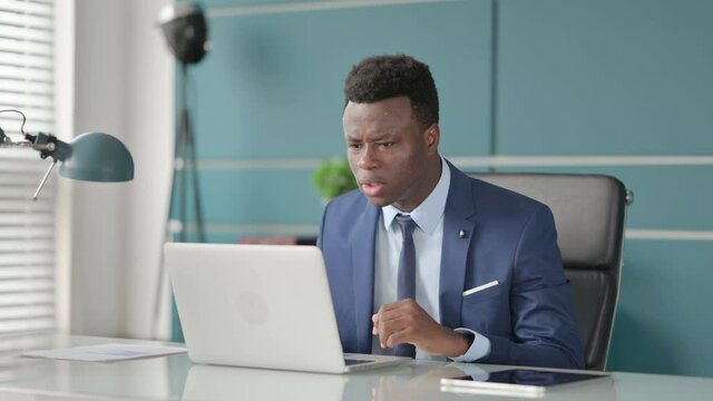 Angry African Man Fighting, Arguing while using Laptop