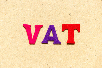 Color cloth alphabet letter in word VAT (abbreviation of value added tax) on wood background