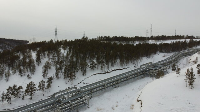 Large pipes filled with water go up the mountain to the state district power station in the city of Yakutsk.
