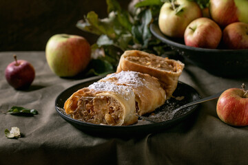 Homemade sliced traditional apple strudel pie and apples