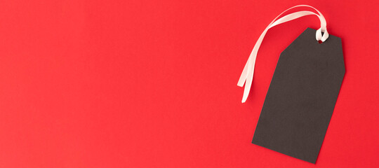 banner with Black Friday sale tag with white ribbon on red background. Black Friday concept.