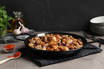 Tasty fried cracklings on grey table. Cooked pork lard
