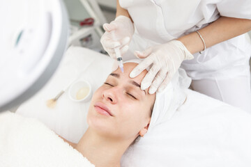 Face Injection. Anti Aging Biorevitalization In Cosmetic Salon.Young beauty Girl Is Receiving...
