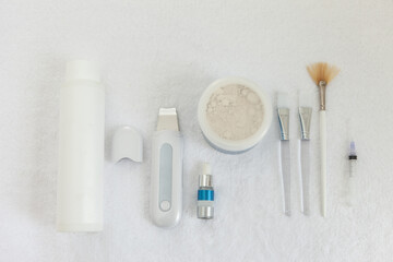 Cosmetic supplies and tools on a white towel. Skin care. Cosmetology. Top view. Flat lay