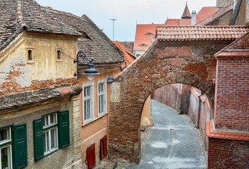 Ancient alley in the medieval town Sibiu, Romania. - 461094122
