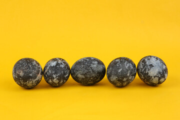 Gray marble painted Easter eggs on yellow background