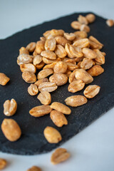 Roasted chili lemon peanuts on stone cutting board