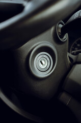 Ignition lock on the steering wheel, close-up. Vertical photography.