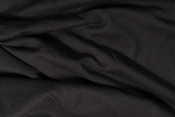 Naklejka na ściany i meble Black background from a wavy fabric texture