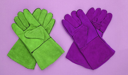 Work gloves on pink background. Top view