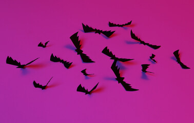 Flying paper cut bats in neon blue pink neon light. Halloween theme