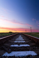 Fototapeta na wymiar Railway in the steppe . photo right after sunset road leading to the distance