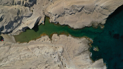 Aerial drone photo of iconic lunar volcanic white chalk beach and caves of Sarakiniko, Milos island, Cyclades, Greece