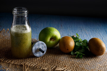 Homemade vegan cucumber smoothie. Homemade vegan smoothie with fresh cucumber, apple, kiwi and mint leaves.