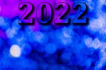 New Year, 2022. Translucent numbers of the year on a blue-toned background of bright lights out of focus. Horizontal design. Happy New Year 2022.