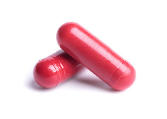 Red pills in capsules isolate on white background