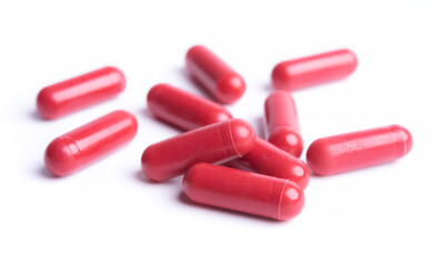 Red pills in capsules isolate on white background