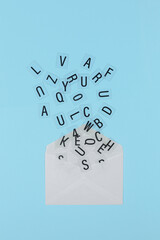 letters coming out of white envelope
