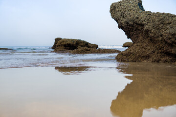 Beautiful ocean landscape, the coast of Cadiz, Conil, rocks on the sandy beach
