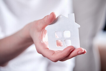 woman hands holding house icon