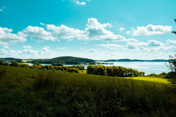 Fototapeta premium Photo of amazing and beautiful nature with green grass, blue sky and river