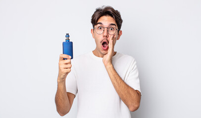 young hispanic man feeling shocked and scared. smoke vaporizer concept