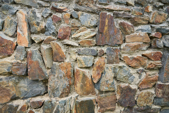 A detailed picture of a stone wall. Old stone wall texture background for design and decor. High quality photo