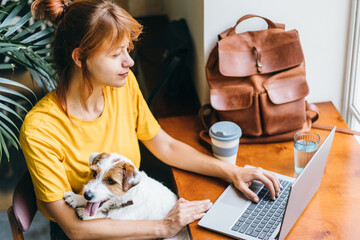 Cozy home, woman in yellow t-shirt watching movie, hugging cute dog. Relax, carefree, comfort...