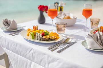 Luxury breakfast food on white table, with beautiful tropical sea view background, morning time summer holiday and romantic vacation concept, luxury travel and lifestyle, resort hotel fruit salad