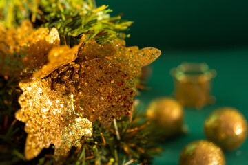 CChristmas tree gold ornaments. Festive macro background. Beautiful toys on the branches. Sparkling bright blurred background bokeh copy space. Beautiful green gold colors of New Year. Mockup postcard