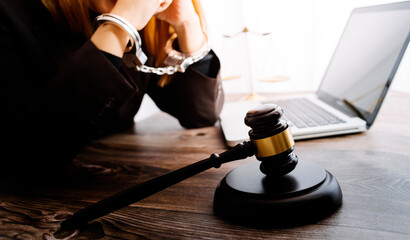 Justice and law concept.Male judge in a courtroom with the gavel, working with, computer and...