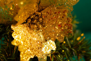 Christmas tree gold ornaments. Festive macro background. Beautiful toys on the branches. Sparkling bright blurred background bokeh copy space. Beautiful green gold colors of New Year. Mockup postcards