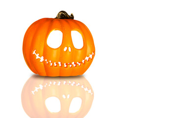 Isolated Pumpkin head Jack-o'-lantern close-up on white background with reflection