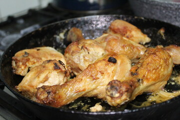 fried chicken drumstick in a cast-iron pan