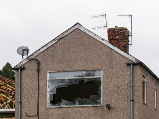 Broken window on derelict house, UK