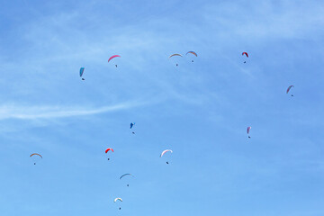 Paragliders in a blue sky