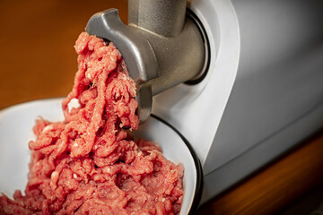 he process of twisting meat in a meat grinder. Minced pork and beef. Meat mince.