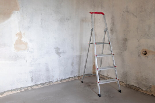 Building stepladder stands in empty room