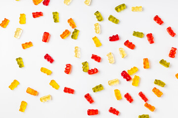 Background from multi-colored marmalade in the form of bears on a white background