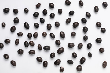Scattering of chocolate dragee background on white background