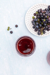 Grape juice with a bunch of grapes on a blue background .