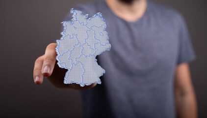 a virtual germany land map digital in hand 3d. - obrazy, fototapety, plakaty